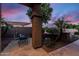 Cozy front patio with seating, framed by mature palm trees and a serene, landscaped environment at 1528 E Harrison St, Gilbert, AZ 85295