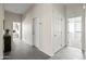 Spacious hallway with stone tile flooring and neutral walls, providing access to other rooms in the home at 1528 E Harrison St, Gilbert, AZ 85295