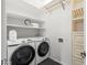 Organized laundry room with a new washer and dryer, storage shelves, and cabinet, offering a functional space at 1528 E Harrison St, Gilbert, AZ 85295
