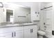 Well-lit bathroom with dual sinks, granite countertops, framed mirror, a vanity, and a shower-tub combination at 16010 S Elizabeth Pl, Arizona City, AZ 85123