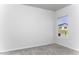 Minimalist bedroom with plush carpet, neutral paint and a window letting in natural light at 16010 S Elizabeth Pl, Arizona City, AZ 85123