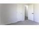 Spare bedroom with plush carpet and neutral paint and a hallway door open to the hallway at 16010 S Elizabeth Pl, Arizona City, AZ 85123