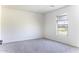 Bright bedroom with soft carpet, neutral paint, and a window offering views of the neighborhood at 16010 S Elizabeth Pl, Arizona City, AZ 85123
