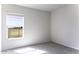 Bright bedroom features neutral carpet, a window for natural light, and a fresh, neutral color scheme at 16010 S Elizabeth Pl, Arizona City, AZ 85123