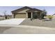 Charming single-story home with a two-car garage, desert landscaping and a covered front porch at 16010 S Elizabeth Pl, Arizona City, AZ 85123