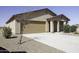 Single-story home boasts a two-car garage, low-maintenance desert landscaping and a covered front porch at 16010 S Elizabeth Pl, Arizona City, AZ 85123