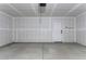 View of a spacious, unfinished garage with a door and an electrical outlet, ready for personalization at 16010 S Elizabeth Pl, Arizona City, AZ 85123