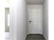 Bright hallway with neutral paint, vinyl floors and a view into the living room at 16010 S Elizabeth Pl, Arizona City, AZ 85123