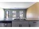 Modern kitchen sink with dual basins and stainless steel faucet with sunlit windows overlooking the yard at 16010 S Elizabeth Pl, Arizona City, AZ 85123