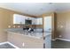 Bright kitchen features white cabinets, granite countertops, stainless steel appliances, and stylish fixtures at 16010 S Elizabeth Pl, Arizona City, AZ 85123