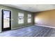 Open concept living room with durable flooring, neutral paint, large windows, and access to the backyard at 16010 S Elizabeth Pl, Arizona City, AZ 85123