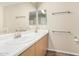 Bright bathroom features a double sink vanity with modern faucets and a large mirror at 16508 N 114Th Dr, Surprise, AZ 85378