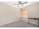 This cozy bedroom features neutral carpet and a ceiling fan at 16508 N 114Th Dr, Surprise, AZ 85378