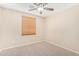 Cozy bedroom with a ceiling fan and neutral carpeting with a window that lets in natural light at 16508 N 114Th Dr, Surprise, AZ 85378