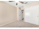 Comfortable bedroom with a ceiling fan, neutral carpeting, and a closet with sliding doors at 16508 N 114Th Dr, Surprise, AZ 85378