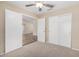 A well-lit bedroom featuring carpet and a large closet at 16508 N 114Th Dr, Surprise, AZ 85378