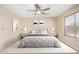 Calm primary bedroom with natural light, neutral color scheme and a ceiling fan at 16508 N 114Th Dr, Surprise, AZ 85378