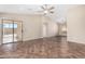 Open living room with tile flooring, a ceiling fan, and sliding glass doors to the backyard at 16508 N 114Th Dr, Surprise, AZ 85378