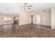 Spacious open-concept living area with tile flooring, ceiling fan, and access to the kitchen at 16508 N 114Th Dr, Surprise, AZ 85378