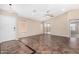 Open living room featuring neutral walls, tile floors, ceiling fan and a view into another room at 16508 N 114Th Dr, Surprise, AZ 85378