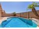 Beautiful backyard featuring a refreshing pool with palm trees at 16508 N 114Th Dr, Surprise, AZ 85378