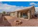 Residential backyard with a patio, fire pit, and low maintenance landscaping at 1773 E Constitution Dr, Chandler, AZ 85225
