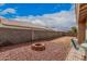 Backyard featuring a fire pit, gravel ground cover, and a low block wall for privacy at 1773 E Constitution Dr, Chandler, AZ 85225