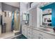 Bright bathroom featuring dual sinks, granite countertops, and shower with gold trim at 1773 E Constitution Dr, Chandler, AZ 85225
