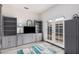 Versatile room with neutral walls, laminate floors, built-in cabinets, a TV, and access to the backyard at 1773 E Constitution Dr, Chandler, AZ 85225