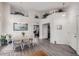Open dining room area featuring laminate floors, white trim, a chandelier, and access to other rooms at 1773 E Constitution Dr, Chandler, AZ 85225