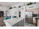 Bright kitchen with an island, breakfast bar, white cabinets, stainless appliances, and stylish decor at 1773 E Constitution Dr, Chandler, AZ 85225