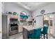 Modern kitchen with stainless steel appliances, granite counters, a breakfast bar, and a tile backsplash at 1773 E Constitution Dr, Chandler, AZ 85225