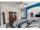 Comfortable main bedroom with wood floors, ceiling fan, ensuite, and blue accent wall at 1773 E Constitution Dr, Chandler, AZ 85225