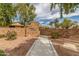 Welcoming entrance to Palomar community with brick signage and lush landscaping offering a tranquil setting at 18861 N Palomar Dr, Sun City West, AZ 85375