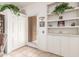 Bright entryway featuring built-in shelving, storage cabinets, and a convenient closet at 18861 N Palomar Dr, Sun City West, AZ 85375