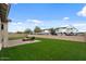 Landscaped backyard featuring a fire pit with seating on a paver patio and artificial turf at 19372 E Timberline Rd, Queen Creek, AZ 85142