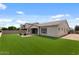 Expansive backyard features a fire pit with seating on a paver patio and artificial turf at 19372 E Timberline Rd, Queen Creek, AZ 85142
