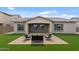 Wide backyard featuring a fire pit with seating on a paver patio and artificial turf at 19372 E Timberline Rd, Queen Creek, AZ 85142