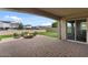 Outdoor living space featuring a fire pit with seating, pavers, and artificial turf at 19372 E Timberline Rd, Queen Creek, AZ 85142
