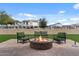 Backyard featuring a fire pit with seating on a paver patio with artificial turf at 19372 E Timberline Rd, Queen Creek, AZ 85142