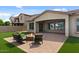 Backyard featuring a fire pit with seating on a paver patio and artificial turf at 19372 E Timberline Rd, Queen Creek, AZ 85142