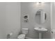 Contemporary half bathroom boasts a modern mirror and vanity at 19372 E Timberline Rd, Queen Creek, AZ 85142
