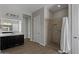 Bright bathroom showcasing a dark vanity, large mirror, and a tiled walk-in shower with grab bar at 19372 E Timberline Rd, Queen Creek, AZ 85142