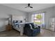 Bright bedroom with a ceiling fan, natural lighting and room for a seating area at 19372 E Timberline Rd, Queen Creek, AZ 85142