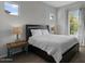 Bedroom featuring decorative lamps and wood-look flooring with a window at 19372 E Timberline Rd, Queen Creek, AZ 85142