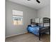 Bedroom with a bunk bed, window, and neutral wall color scheme, creating a cozy atmosphere at 19372 E Timberline Rd, Queen Creek, AZ 85142