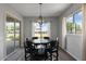 Eat-in kitchen and dining area with elegant lighting fixture and backyard views at 19372 E Timberline Rd, Queen Creek, AZ 85142