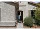 Close up of home's stucco exterior and arched entryway with view of the front door at 19372 E Timberline Rd, Queen Creek, AZ 85142