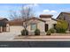 Charming single-story home showcasing desert landscaping, a two-car garage, and a red tile roof at 19372 E Timberline Rd, Queen Creek, AZ 85142