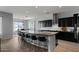 Open kitchen featuring a large island with bar seating, dark cabinets, and modern stainless steel appliances at 19372 E Timberline Rd, Queen Creek, AZ 85142